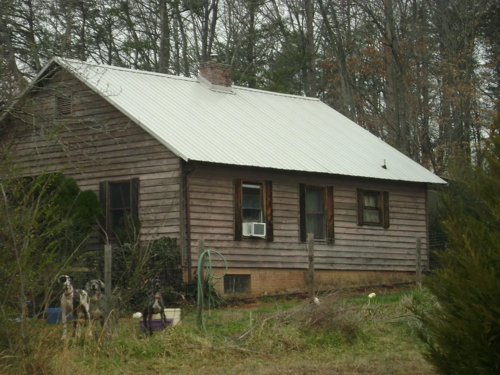 White metal roof on an old wood sided farmhouse, from a Metal Roof Installation job in Knob Noster